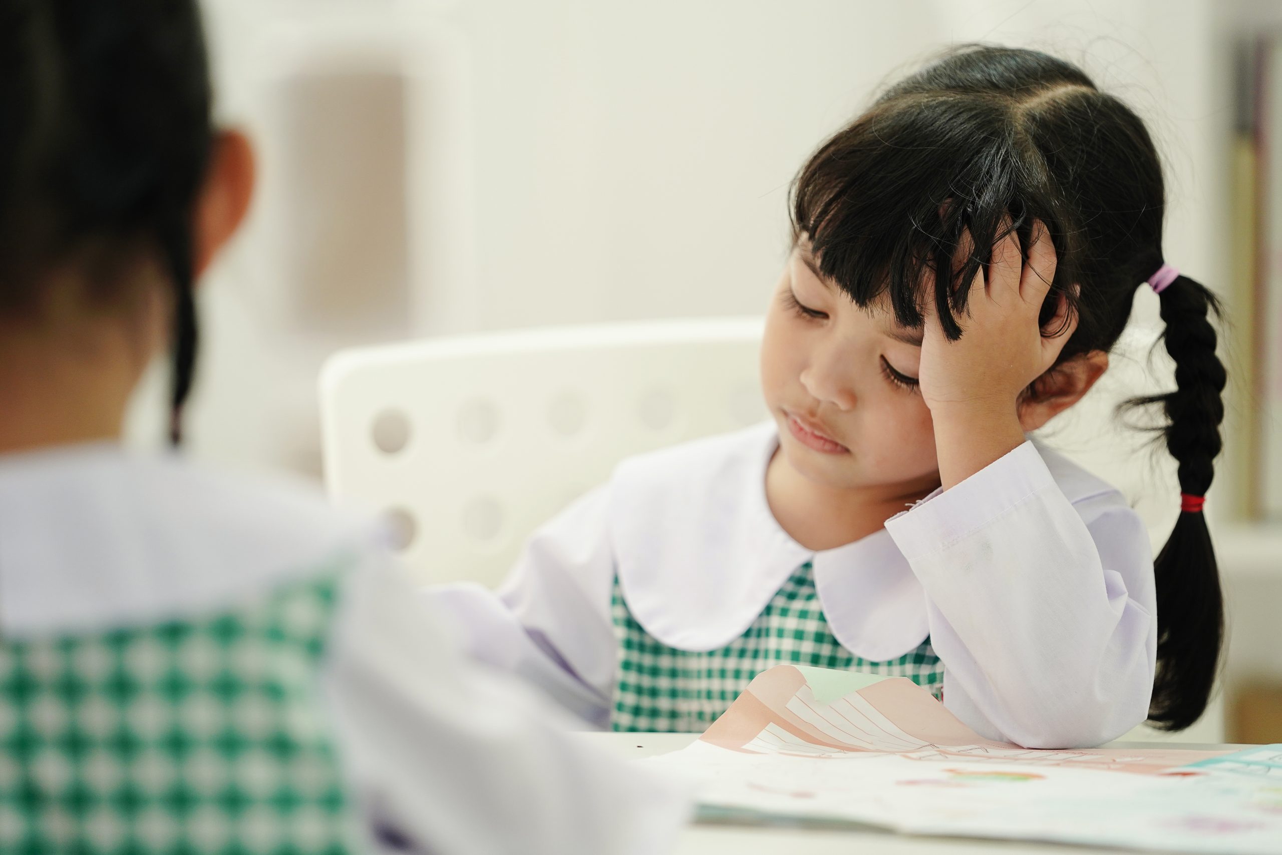 SEND Pathways - Serious Child Girl at elementary school. Unhappy student